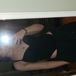 Above the hips black knitted body suit